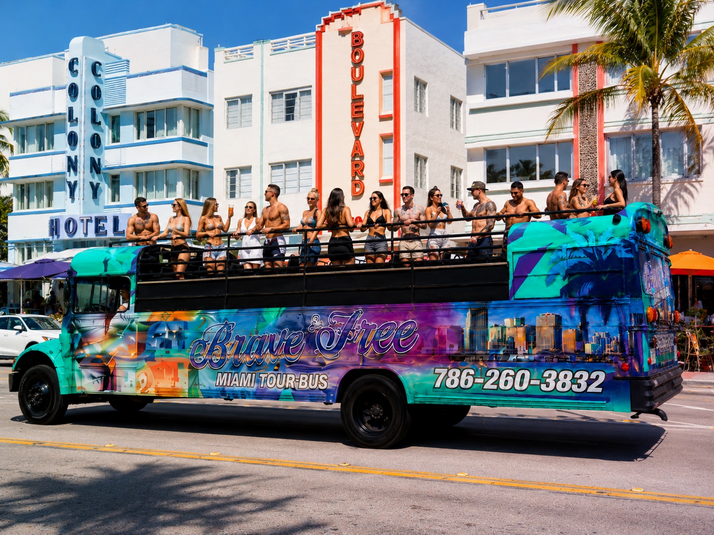Brave & Free party bus rolling down Ocean Drive with a full open-air deck